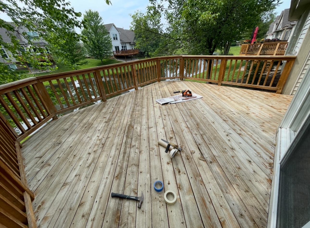 Weathered wood deck cleaned and sanded, ready for stain