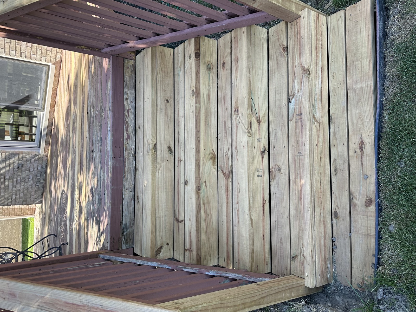 Replacement deck stairs in new pressure-treated lumber between existing railings