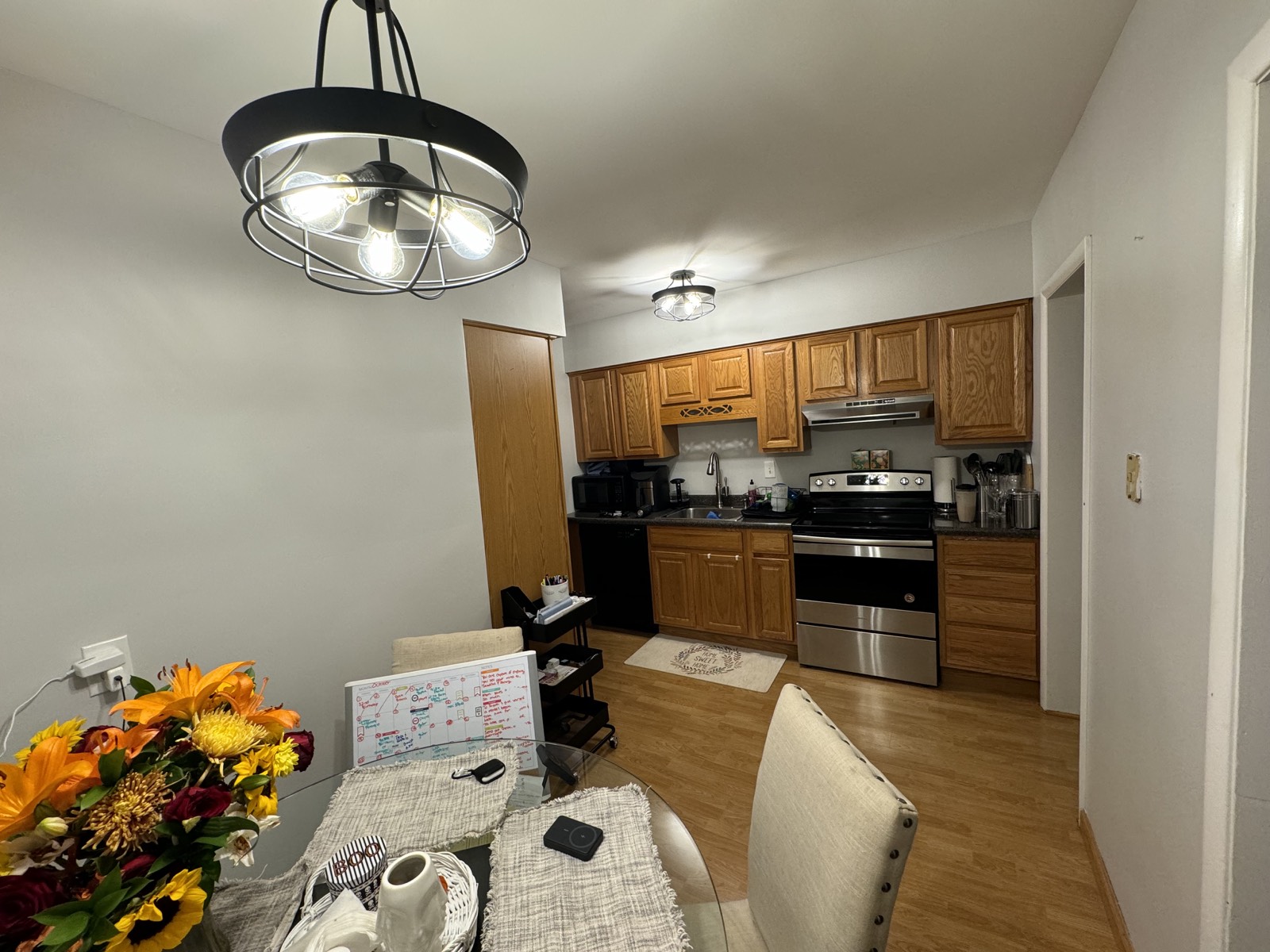Repainted kitchen and dining area with a modern caged chandelier